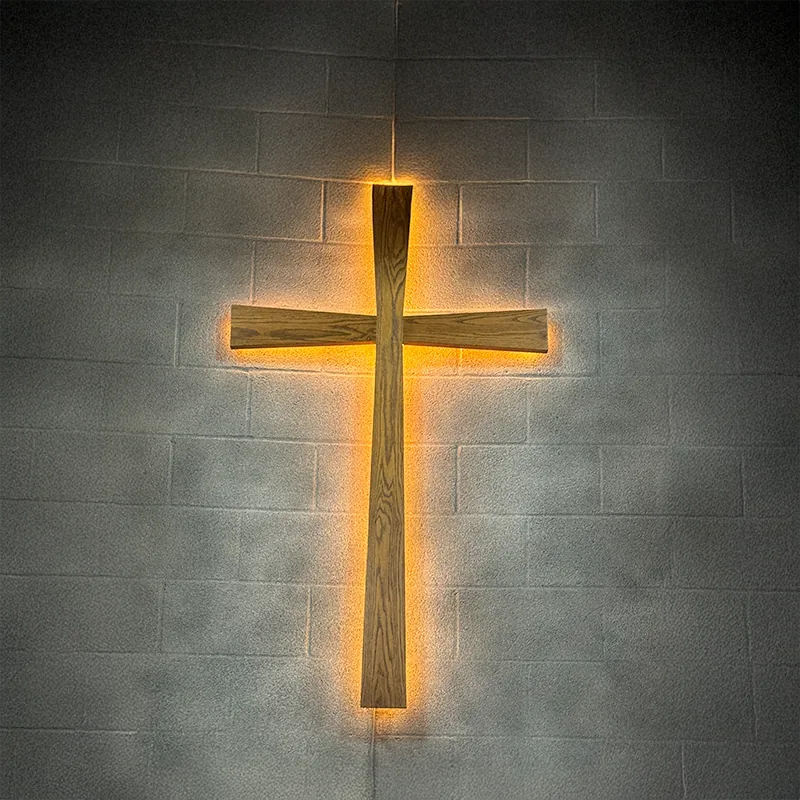 llbc-cross An image of a cross lit from behind on a gray brick wall